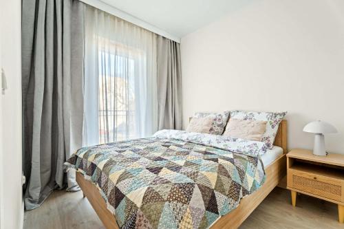 a bedroom with a bed and a window at MDM Apartments in Gdańsk