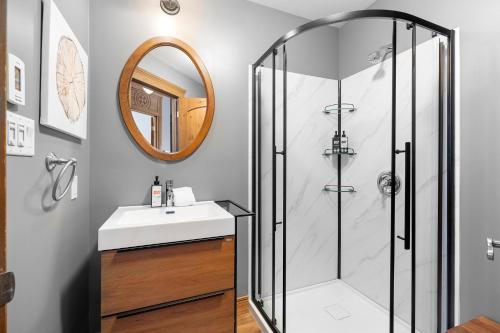a bathroom with a sink and a shower at Les Manoirs 3bdrs W Pool & Hottub Near Village in Mont-Tremblant