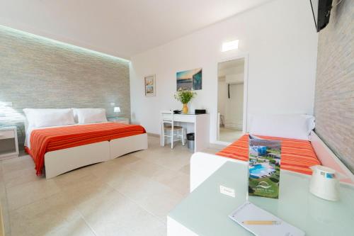 a bedroom with a bed and a desk in a room at Masseria Un Posto al Sole in Otranto