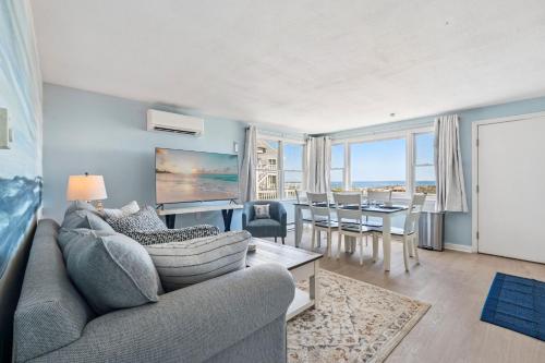 a living room with a couch and a table at Coastal Bliss in Rye