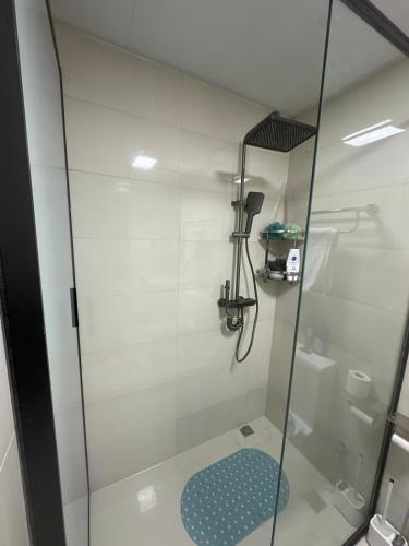 a shower with a glass door in a bathroom at The Nairobi Experience in Nairobi