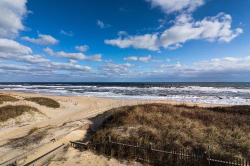 an empty beach with the ocean in the background at 5695 - Pelican's Perch in Nags Head