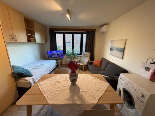 a living room with a table and a living room at Studio in Leuven in Leuven