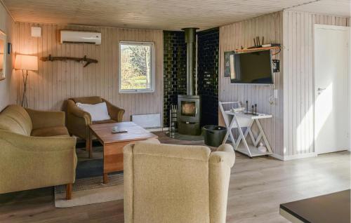 a living room with two chairs and a television at 4 Bedroom Amazing Home In Ørsted in Ørsted