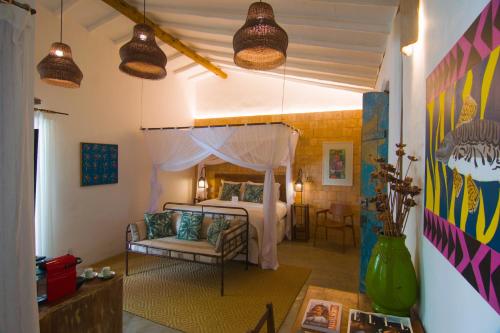 a bedroom with a bed with a canopy at Hotel Boutique Perainda in Trancoso