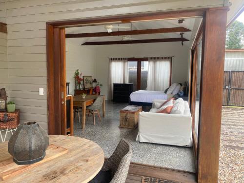a living room with a couch and a bedroom at Mini Mullum Studio Retreat in Mullumbimby