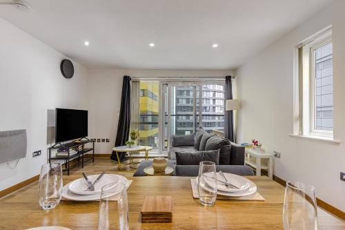 a living room with a couch and a table at Luxury 2 Bed 2 Bath Canary Wharf Apartment with Balcony in London