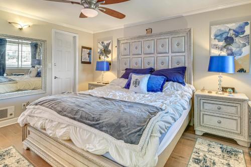 a bedroom with a large bed with blue pillows at Beachfront, Amazing 180-Degree View in Oceanside
