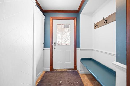 a hallway with blue walls and a door at Le Plateau Ski Inout W 3bdrs W Pool Access in Mont-Tremblant
