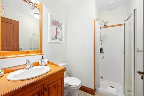 a bathroom with a sink and a shower at Le Plateau Ski Inout W 3bdrs W Pool Access in Mont-Tremblant
