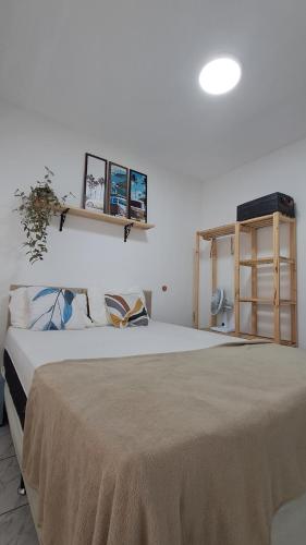 a bedroom with a large bed with a table at Casa Vila Mar Guesthouse in Guaratuba