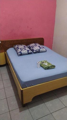 a bed with two pillows and a towel on it at Hotel Baguari in São Paulo
