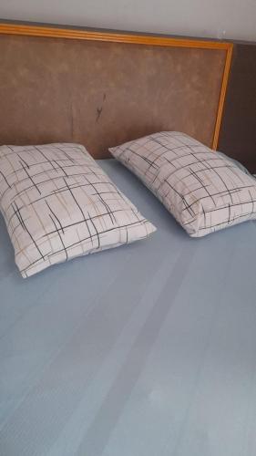 two pillows sitting on top of a bed at Hotel Baguari in São Paulo