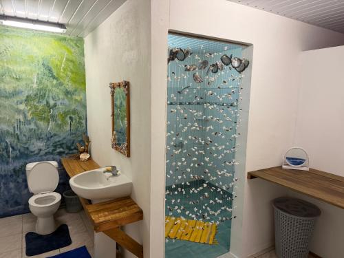 a bathroom with a shower with a toilet and a sink at Le KAHAIA Rangiroa Tiputa in Rangiroa
