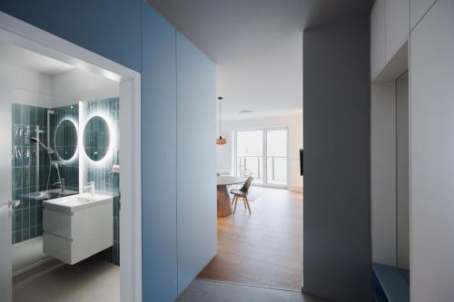 a bathroom with a sink and a mirror at Castle view Vinetto apartment with free parking in Trenčín