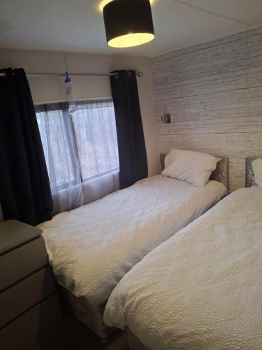 two beds sitting next to each other in a bedroom at No 1 The Glen in Port Seton