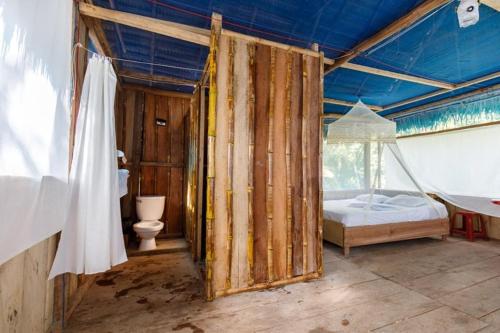 a room with a bed and a hammock in it at Red Uakari Jungle Lodge in Iquitos