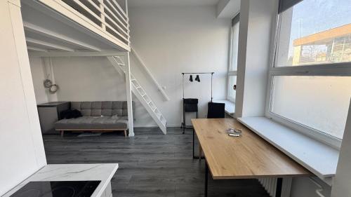 a living room with a couch and a wooden table at atelier in Bratislava