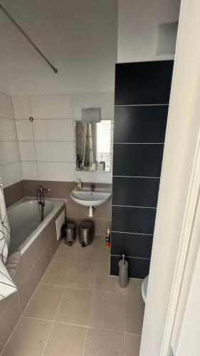 a bathroom with a bath tub and a sink at atelier in Bratislava