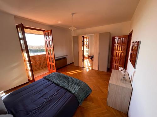 a bedroom with a bed and a wooden floor at Residenza Ticino in Oleggio