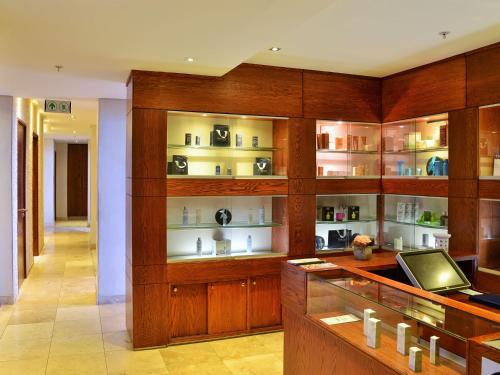 a room with wooden shelves with medicines on them at Premier Hotel East London ICC in East London