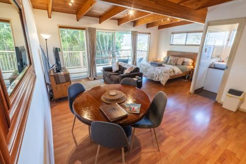 a living room with a wooden table and chairs at Clandulla Cottages & Farmstay in Boyland