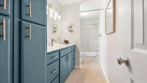 a bathroom with a blue cabinet and a sink at Sea the Good in Panama City Beach