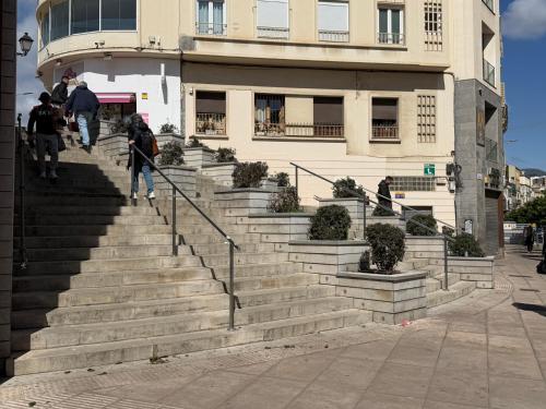 a group of people walking down stairs in front of a building at Ilustre Rooms Malaga in Málaga