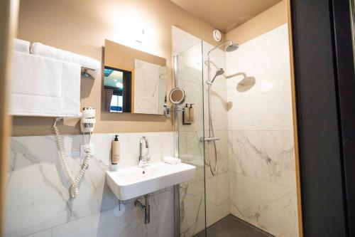a bathroom with a sink and a shower at Bakery Boutique Hotel in Leeuwarden