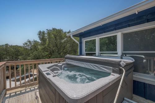 a hot tub on the deck of a house at 4620 - Flip Flop Inn in Southern Shores