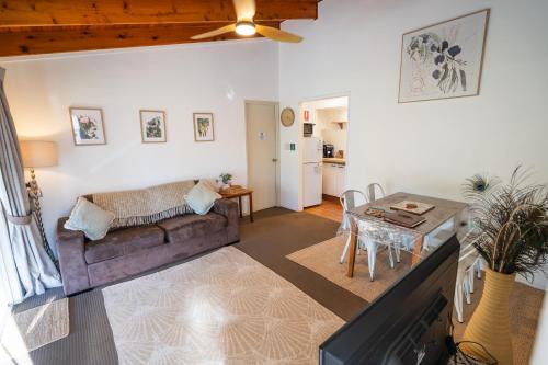 a living room with a couch and a table at Clandulla Cottages & Farmstay in Boyland