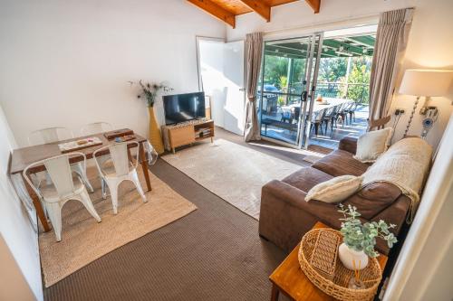 a living room with a couch and a table at Clandulla Cottages & Farmstay in Boyland