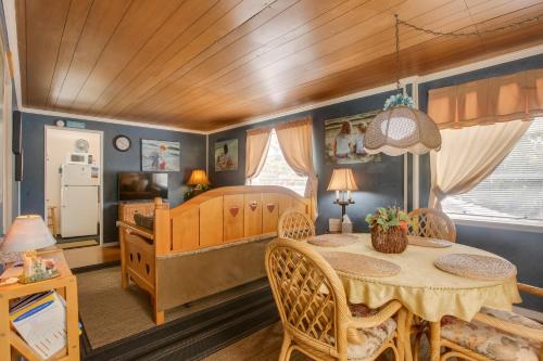 a dining room with a table and a kitchen at Less Than 3 Mi to Golf and Swim Cozy Oasis in Lake Worth! in Lake Worth