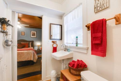 a bathroom with a sink and a bedroom with a bed at Less Than 3 Mi to Golf and Swim Cozy Oasis in Lake Worth! in Lake Worth