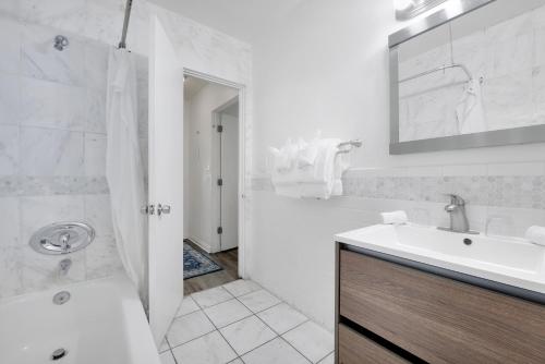 a white bathroom with a sink and a shower at Magic Castle Hotel in Los Angeles