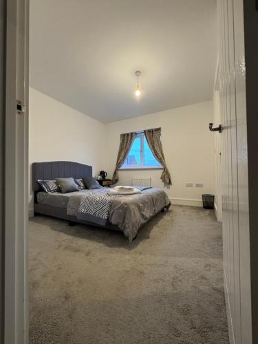 a bedroom with a bed and a window at Beautiful Private Ensuite Minutes to city centre in Stoke on Trent
