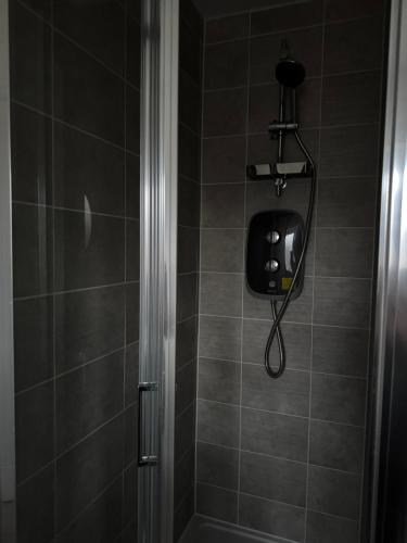 a shower with a soap dispenser in a bathroom at Beautiful Private Ensuite Minutes to city centre in Stoke on Trent