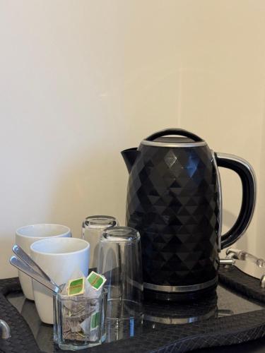a black coffee pot sitting on top of a table at Beautiful Private Ensuite Minutes to city centre in Stoke on Trent