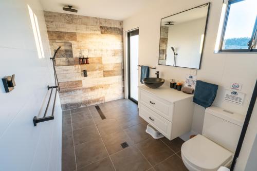 a bathroom with a toilet and a sink at Clandulla Cottages & Farmstay in Boyland