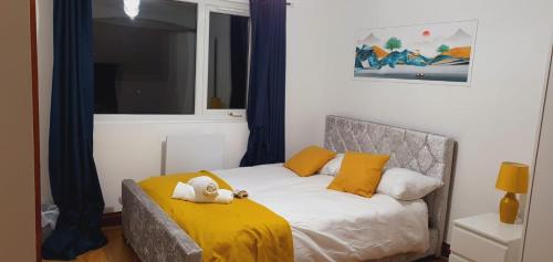 a bedroom with a bed with a stuffed animal on it at Marahomes in Bushey