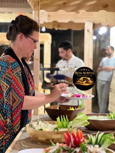 a woman standing in a kitchen preparing food at Star night in Disah
