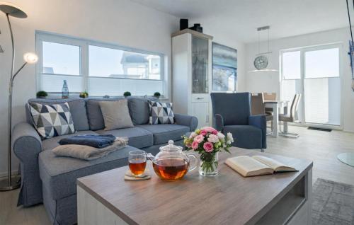 a living room with a couch and a table at Mein Herzensort in Olpenitz