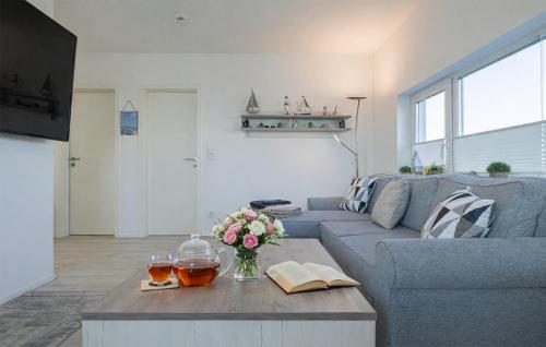 a living room with a blue couch and a coffee table at Mein Herzensort in Olpenitz