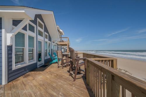 a beach house with a deck with a view of the beach at 7677 - Weathering Heights in Avon