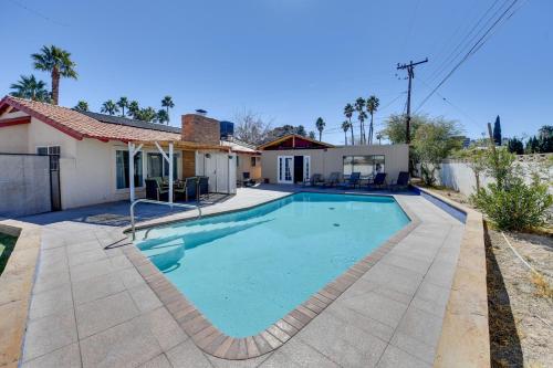 a swimming pool in front of a house at Elegant Home with Pool Table 3 Mi to Vegas Strip! in Las Vegas
