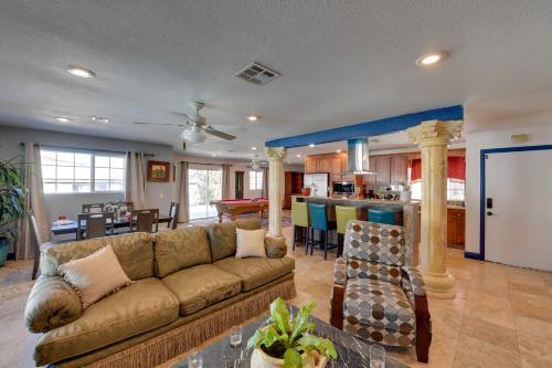 a large living room with a couch and a kitchen at Elegant Home with Pool Table 3 Mi to Vegas Strip! in Las Vegas