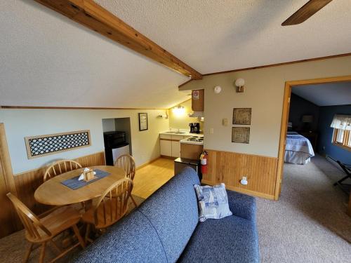a living room with a blue couch and a table at Bayfield Island View Lodging, Bayfield, WI in Bayfield