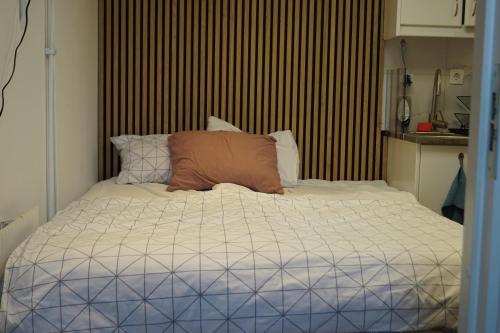 a bed with a brown pillow on top of it at BRABO in Landskrona