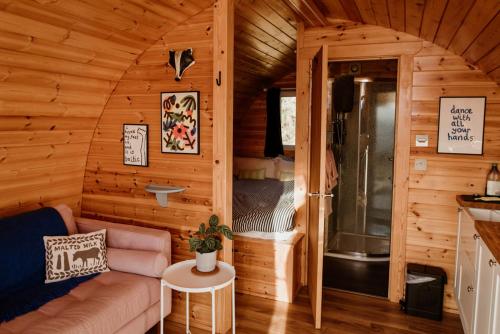 a living room with a couch in a cabin at The Sleepy Crofter Glamping - Achiltibuie in Achiltibuie