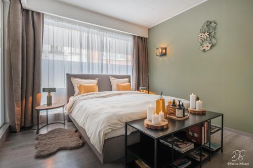 a bedroom with a large bed and a window at A Beloeil, On Vous Acceuille in Beloeil
